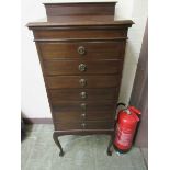 An Edwardian mahogany seven drawer music cabinet on cabriole supports