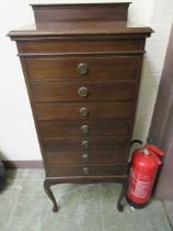 An Edwardian mahogany seven drawer music cabinet on cabriole supports