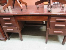 An oak pedestal desk of seven drawers