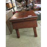 A small wooden stool Split to top. Minor knocks and scratches throughout.