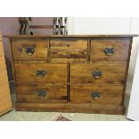 A modern dark wood finish sideboard chest of eight drawers
