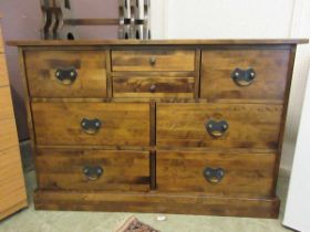 A modern dark wood finish sideboard chest of eight drawers