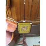 A Victorian mahogany fire screen with later embroidered panel