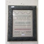 A modern embroidery sampler marked 'TB 2000' in traditional brass finish finish frame