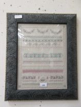 A modern embroidery sampler marked 'TB 2000' in traditional brass finish finish frame