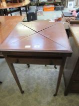 An Edwardian inlaid mahogany envelope card table