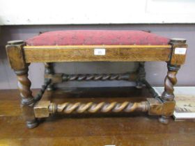 An early 20th century oak foot stool with barley twist legs and stretchers