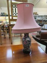 A Chinese floral table lamp with pink shade