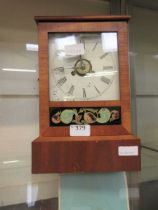 A beech cased mantle clock with painted face