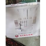 A boxed Singer 2/3/4 thread overlock sewing machine