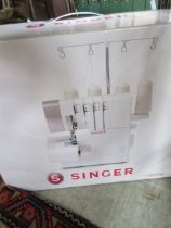 A boxed Singer 2/3/4 thread overlock sewing machine