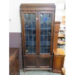 An oak and glazed double door display cabinet Dimensions: H, 194cm , W, 86cm , D, 35cm.