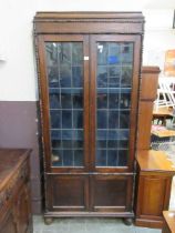An oak and glazed double door display cabinet Dimensions: H, 194cm , W, 86cm , D, 35cm.