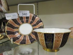 A bowl and saucer by Royal Worcester with red, blue, and gilt geometrical decoration Crack to saucer