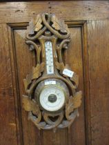 A beech framed barometer/thermometer