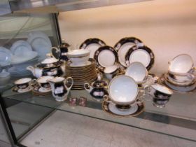 A large selection of blue and gilt design Rosenthal tableware along with two gilt framed miniature