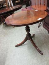 A reproduction mahogany tripod table