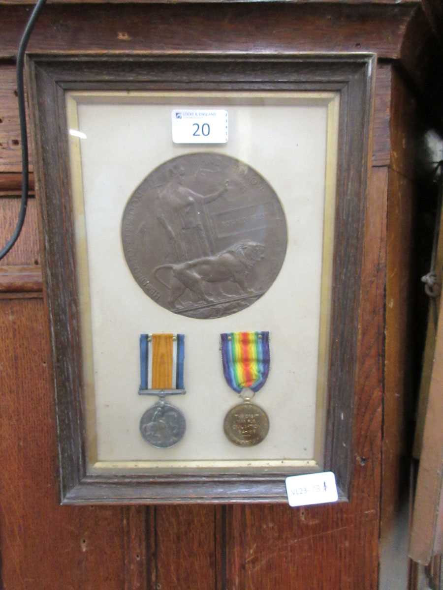 A WWI death plaque and pair of medals framed together, awarded to Ronald Priest