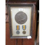 A WWI death plaque and pair of medals framed together, awarded to Ronald Priest