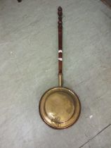 A copper and brass bed warming pan