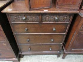 An early 20th century oak chest of two short over three long drawers