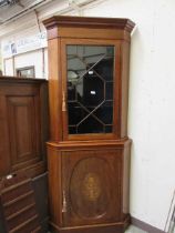 An Edwardian Sheraton revival mahogany full height inlaid cabinet having glazed door to top with