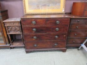 An early 20th century oak chest of two short over three long drawers on bracket feet