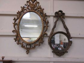 An ornate gilt framed mirror together with one other