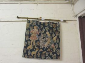 A reproduction period style embroidery on brass curtain rod