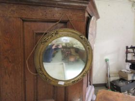 An ornate gilt framed circular convex mirror