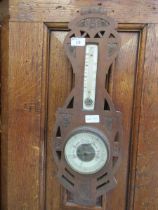 An early 20th century carved wooden banjo barometer