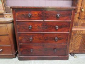 A Victorian flame mahogany chest of two short over three long graduating drawers