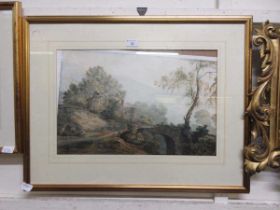 A gilt framed and glazed possible watercolour of countryside scene with cottage and bridge