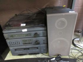 A Sanyo stereo sound system with a pair of matching speakers
