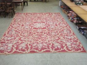 A substantial pink floral rug, measurements 562cm x 336cm