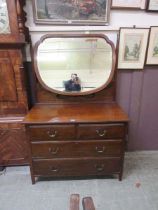An early 20th century walnut chest of two short over two long drawers with swing mirror to back