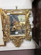 An ornate gilt framed bevel glass wall mirror (A/F)