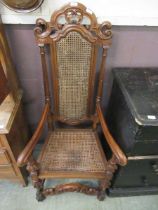 An early 20th century reproduction carved back open armchair with bergere seat and back (A/F)