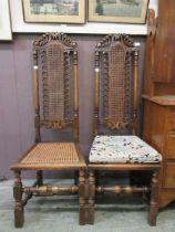 A pair of early 20th century reproduction oak high back chairs with bergere backs