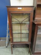 An Edwardian walnut glazed display cabinet with painted design