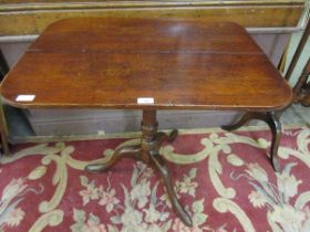 A 19th century oak tilt top pedestal table