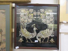 A framed and glazed silk embroidery of peacocks