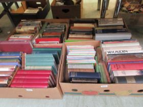 Four trays of various hardback books to include reference books, novels, etc