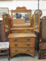 An early 20th century satinwood dressing chest having triple mirror to back, the base having three