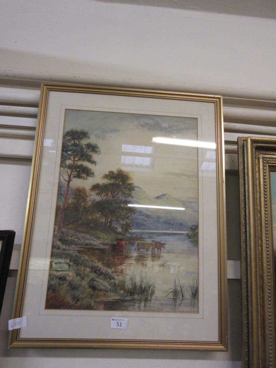 A framed and glazed possible watercolour of highland cattle in lake scene