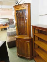 A yew full height corner display cabinet having glazed door to top with door below