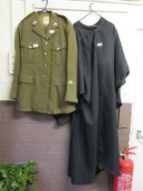 A green army jacket with trousers together with an academic black gown