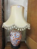 An ornate gilt painted ceramic table lamp