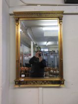 A reproduction Regency style gilt framed bevelled glass wall mirror