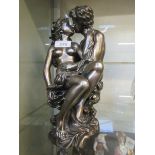 A resin moulded figural group of lovers